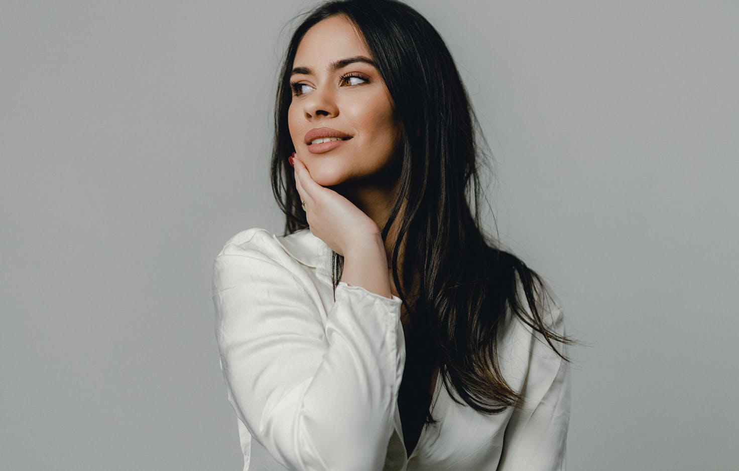 model holding face and neck
