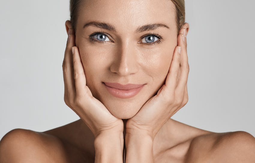 Woman holding her face