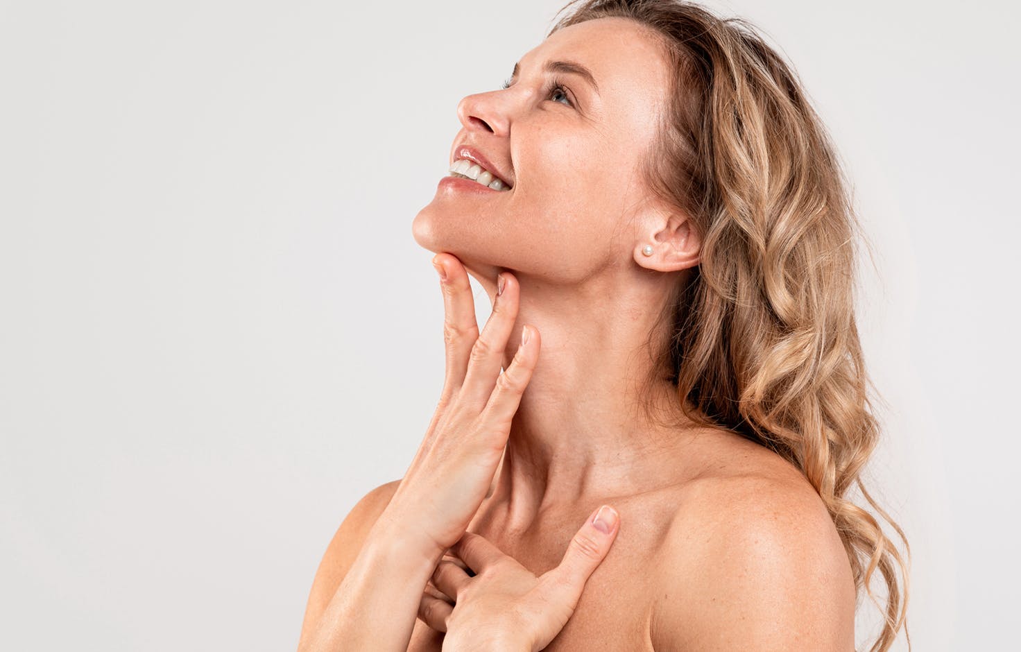 woman touching her neck