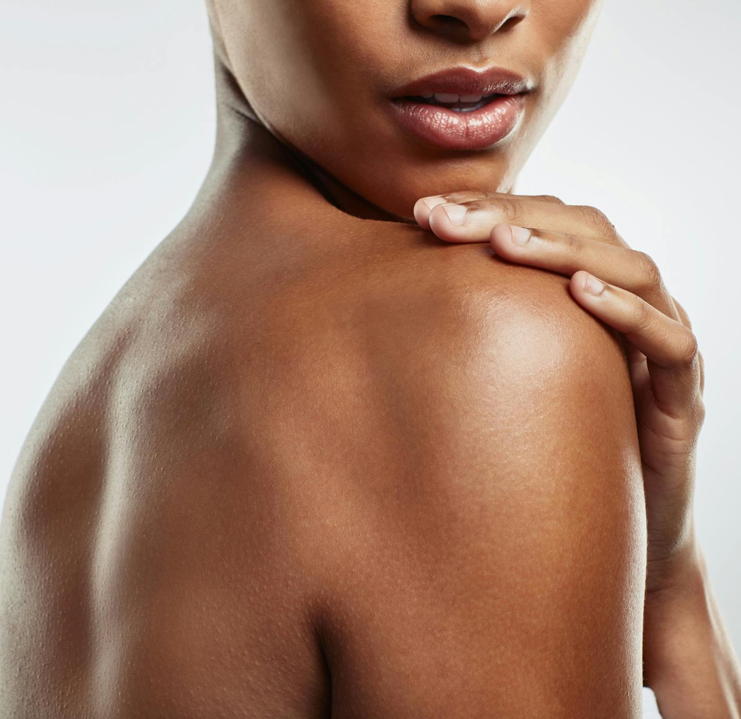 Woman touching her shoulder