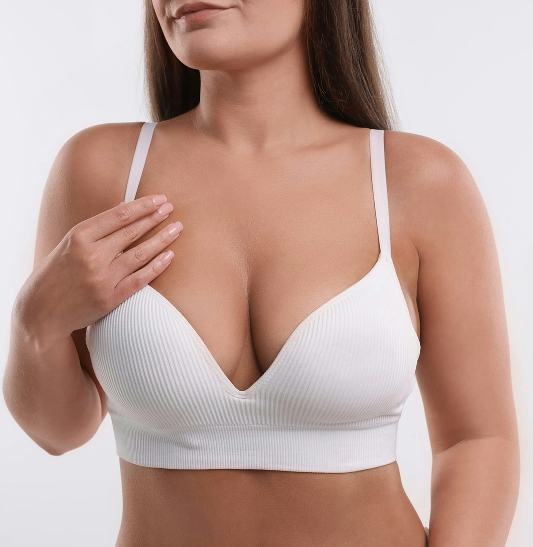 close up on woman's breast in a white bra