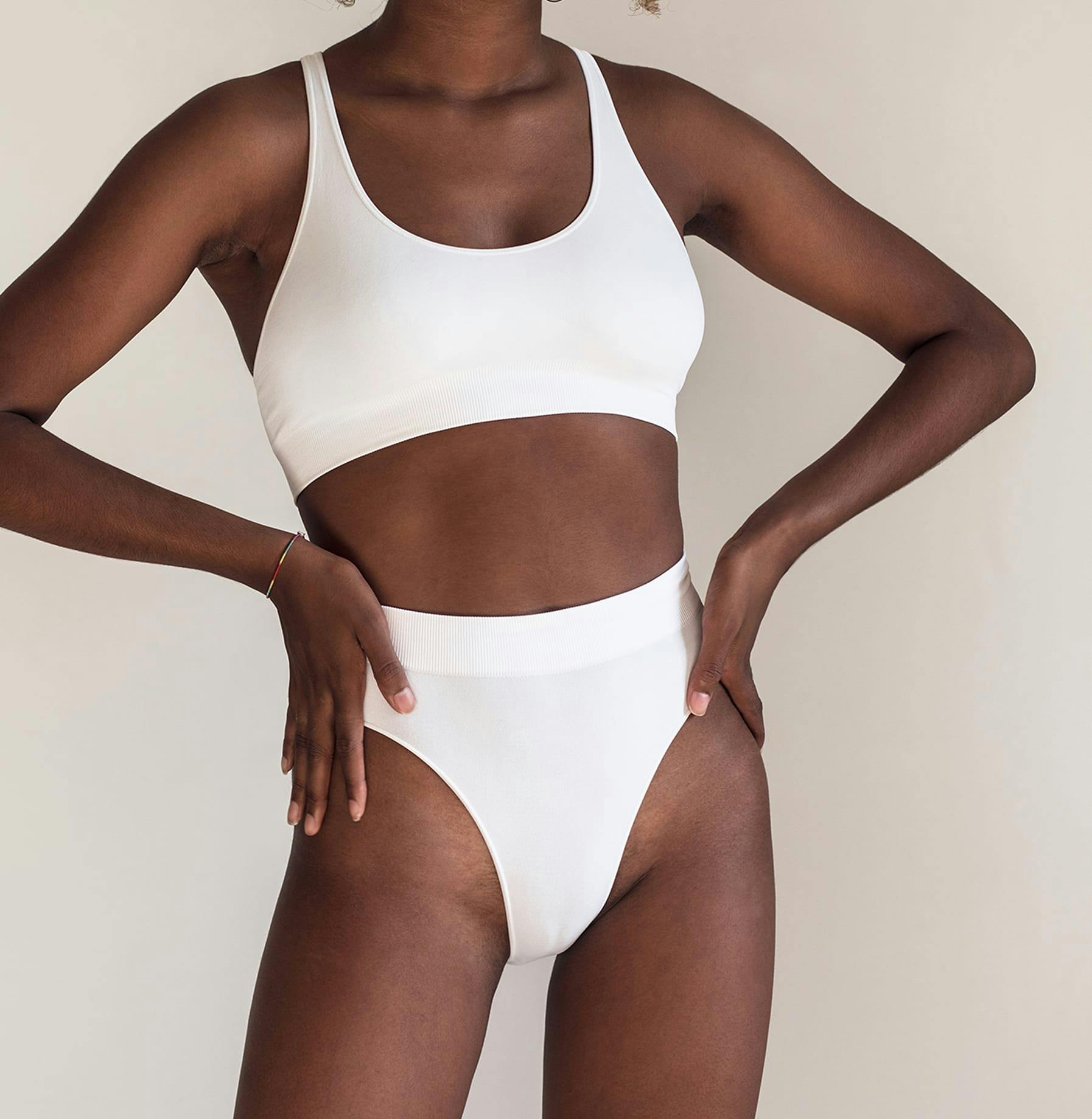 a woman's body wearing a white top and white underwear