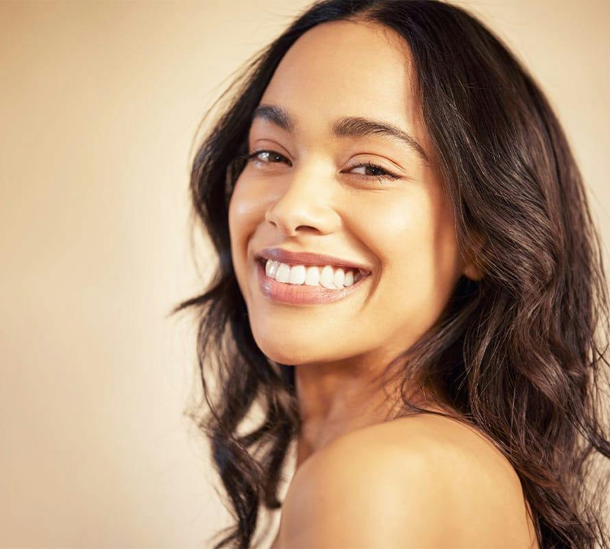 woman smiling with long brunette hair