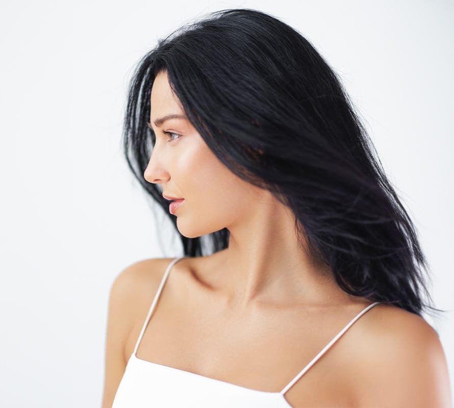 woman with long black hair looking to the left