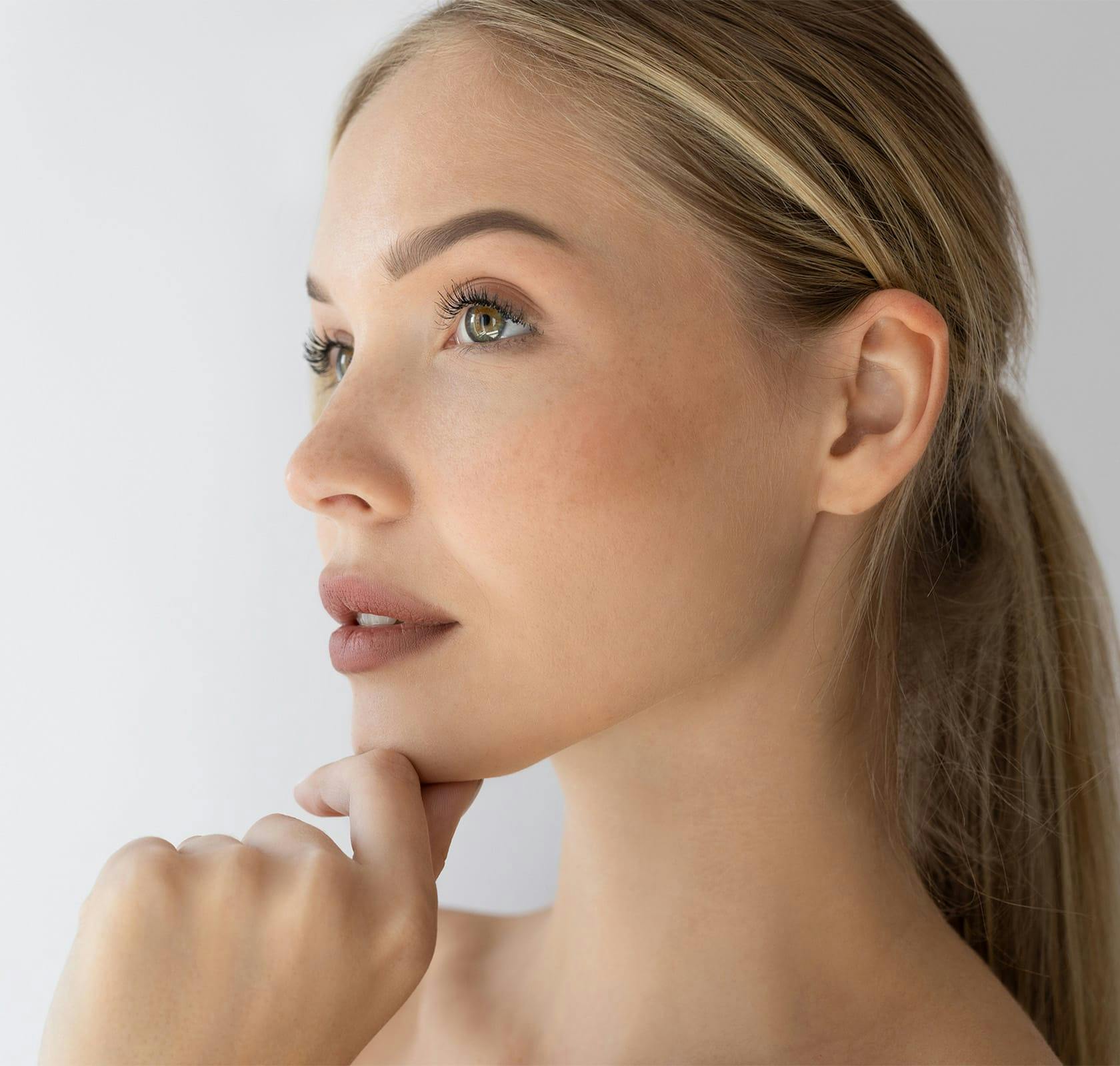 blonde woman with hand on her chin