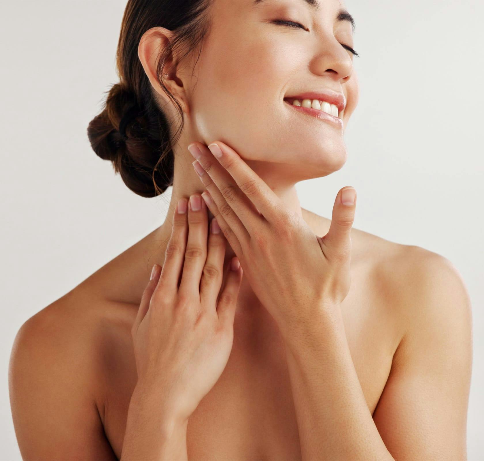 woman with her hands on her neck