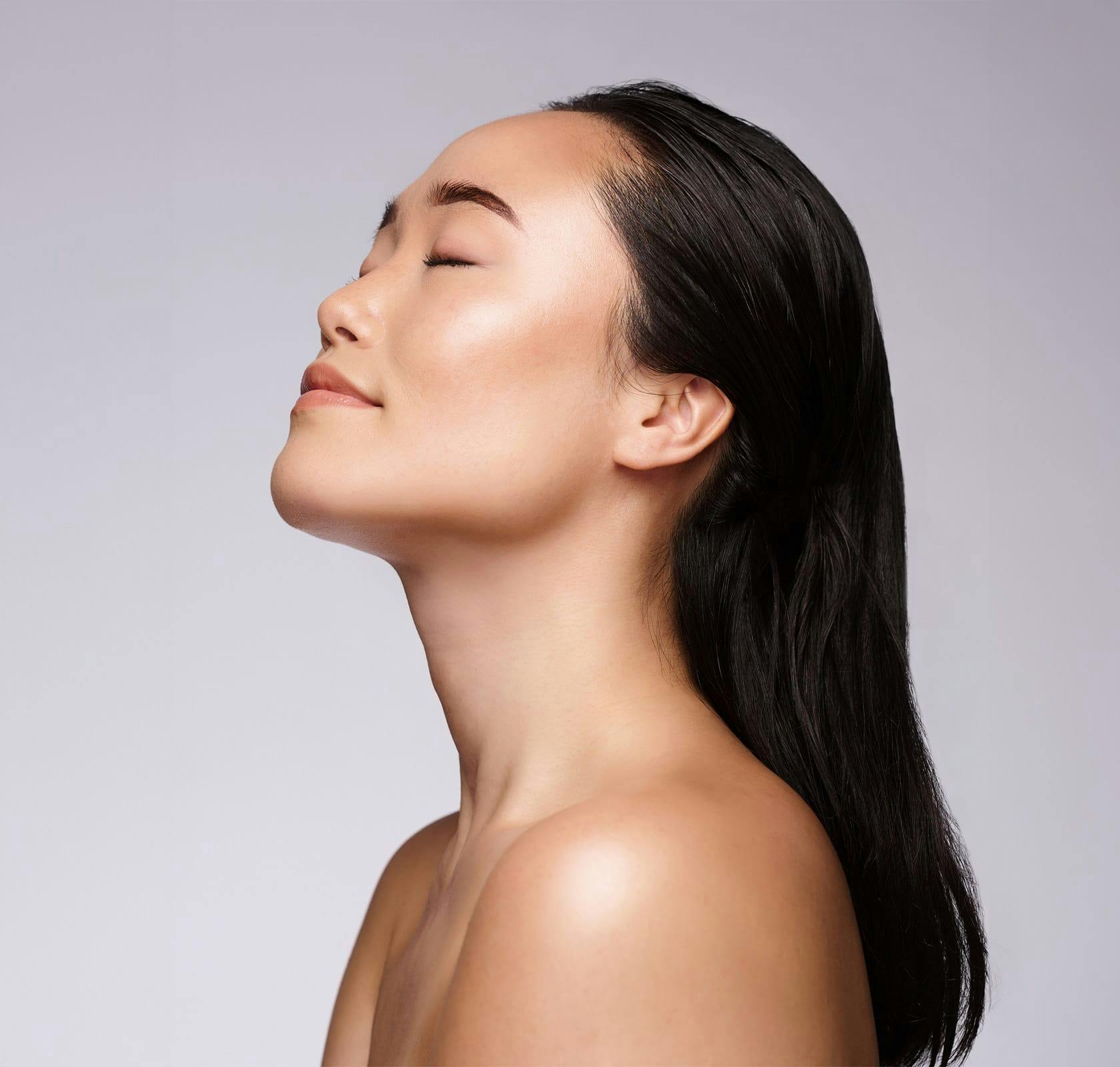 woman with eyes closed smiling