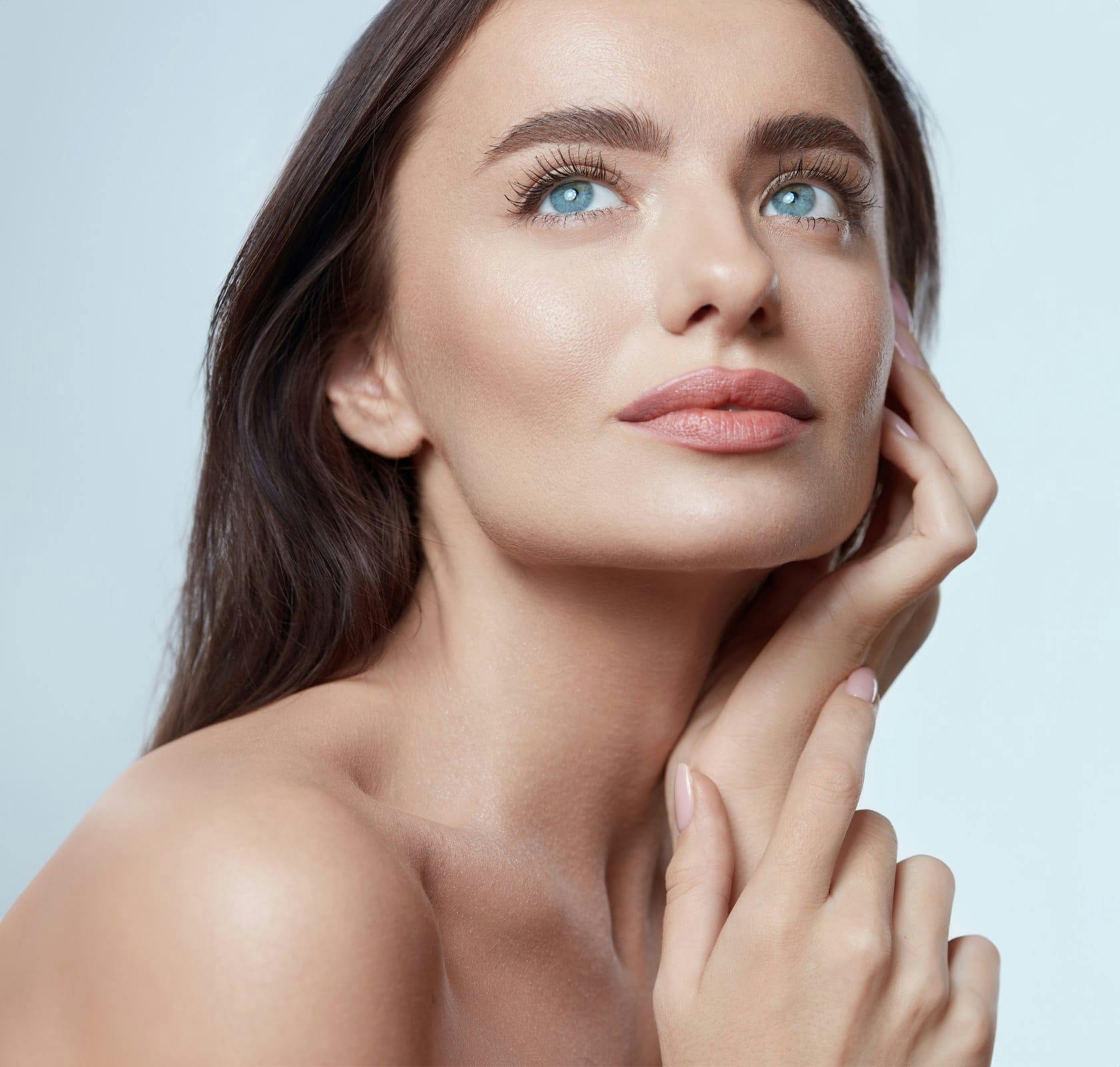 woman with hand on her face