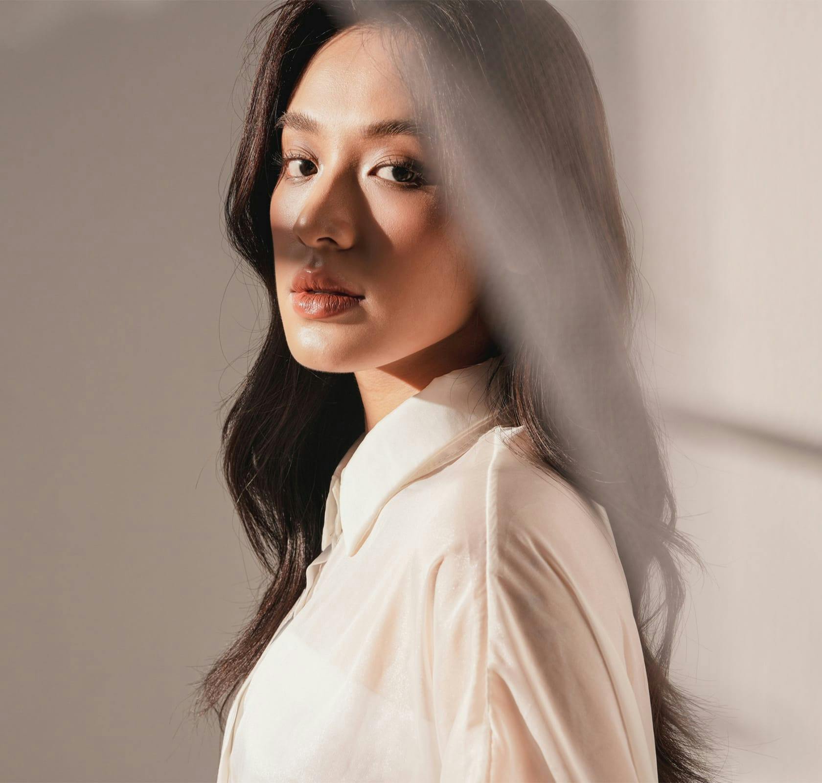 dark haired woman looking at camera