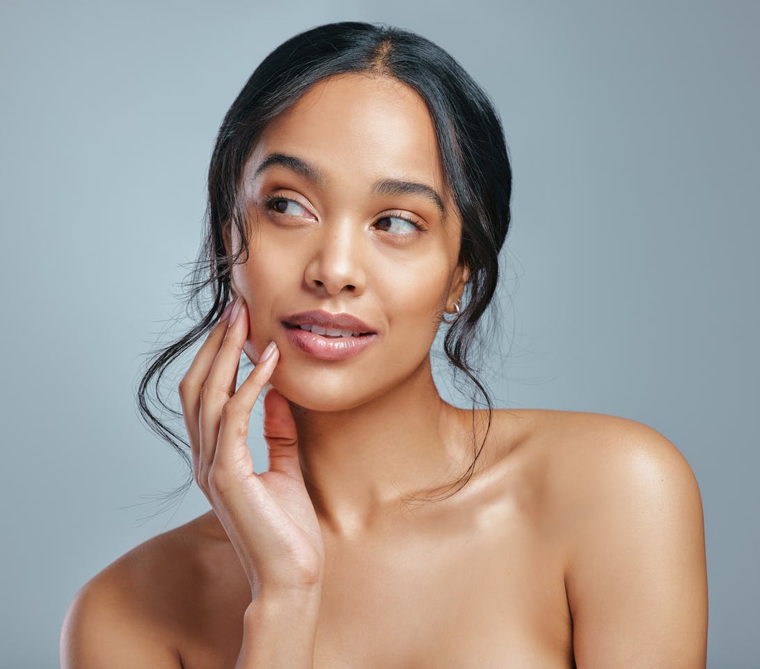 Woman touching the left side of her cheek