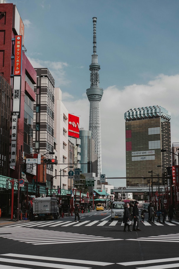 cars parked on street near high rise buildings during daytime