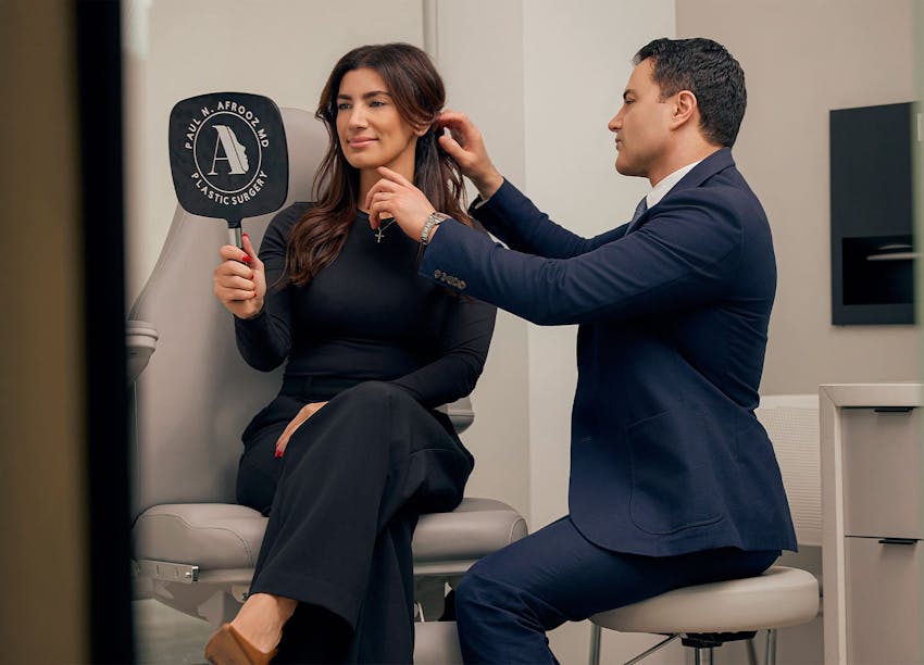 Woman looking in mirror during consultation