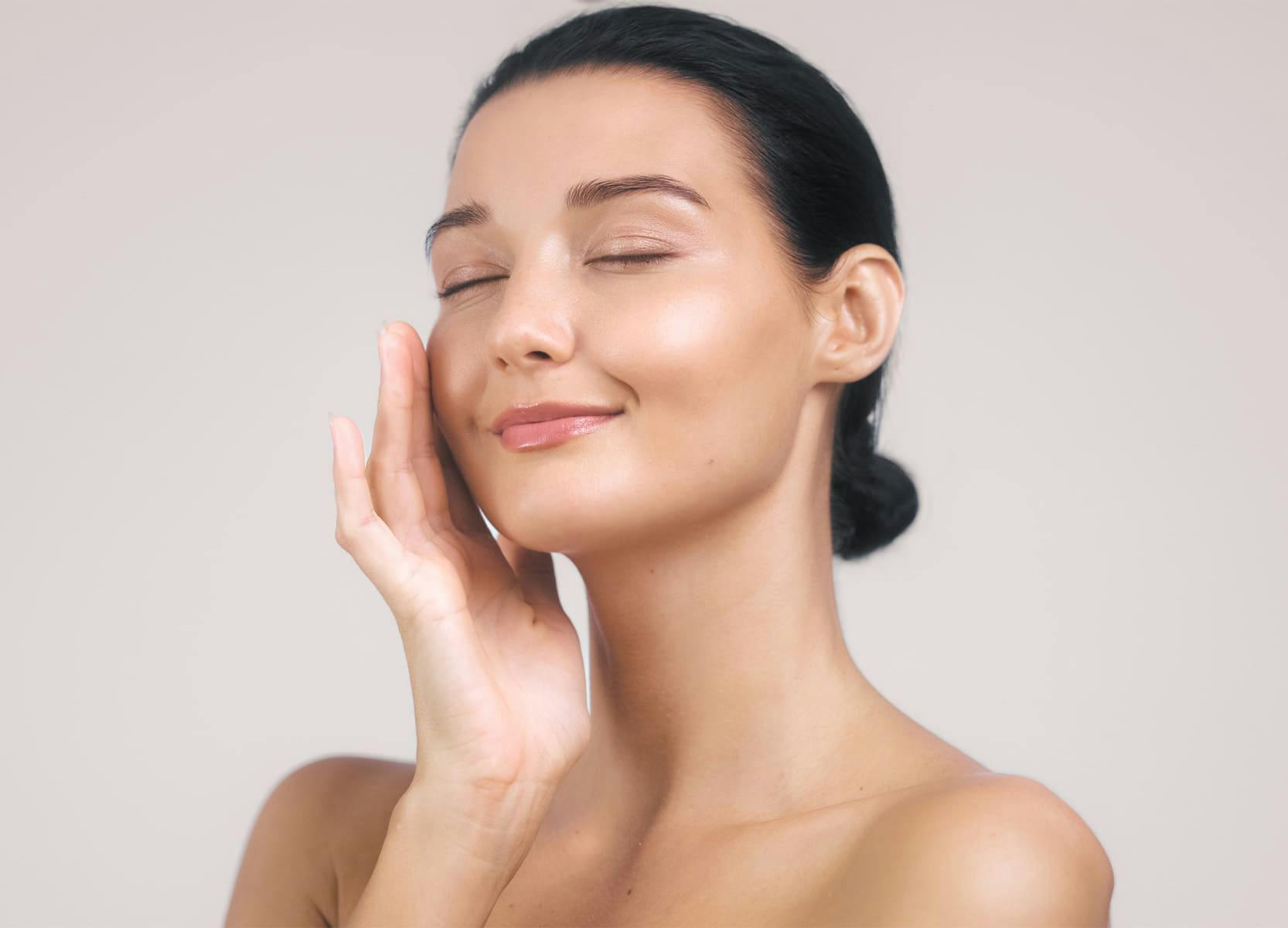 woman tpuching her skin