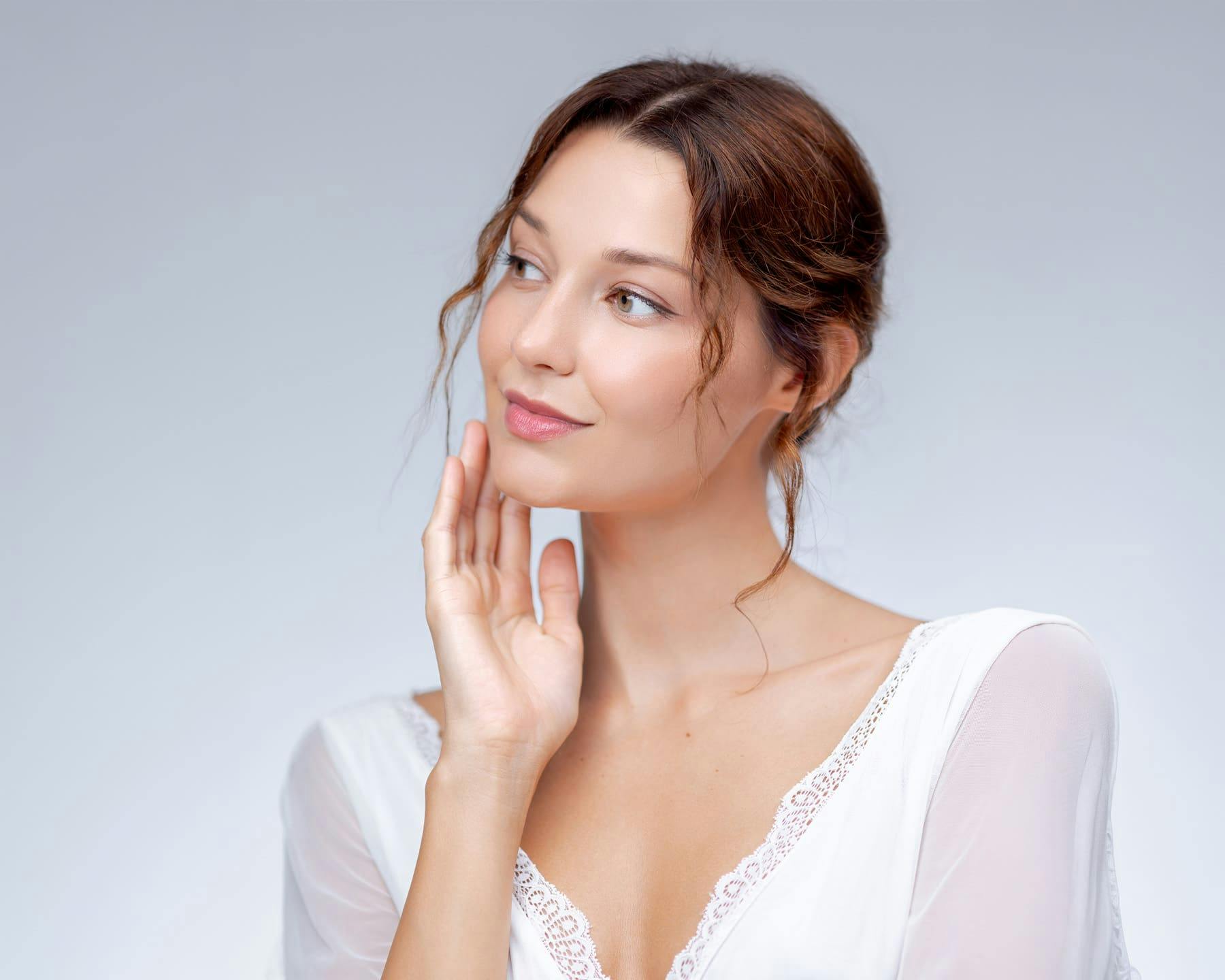 Woman smiling while touching chin