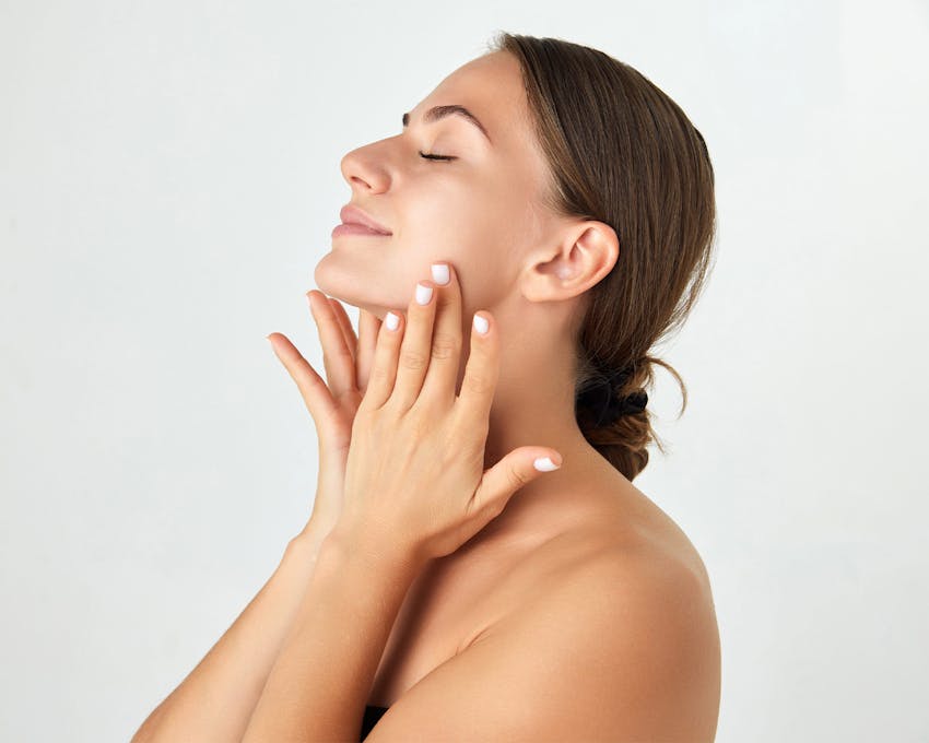 woman touching her neck