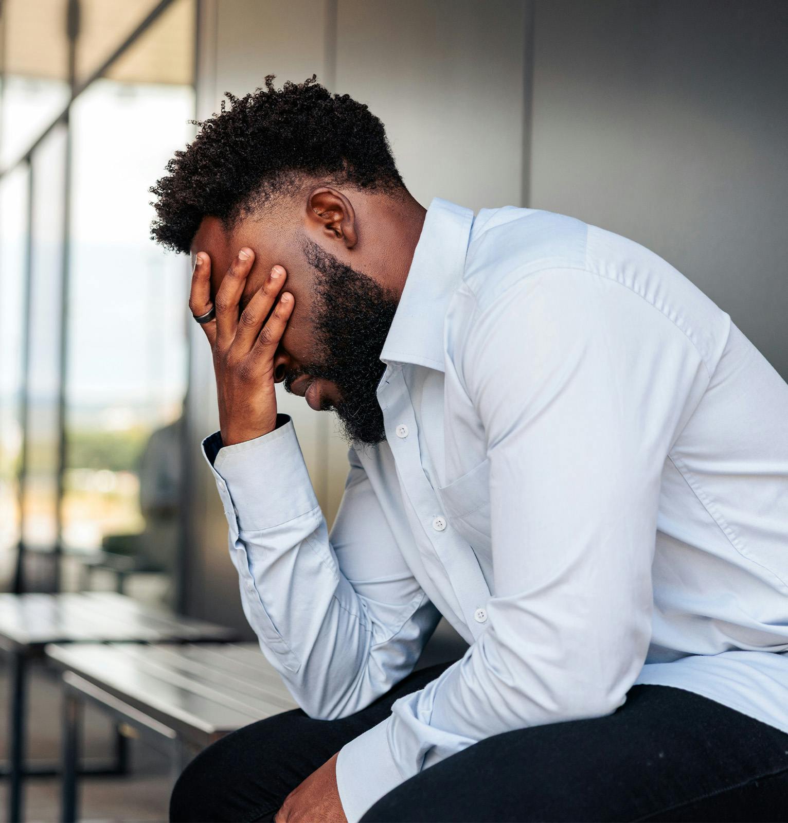 Man with his hand covering his face