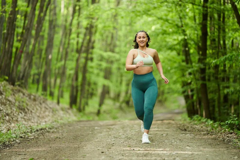 woman jogging in forest