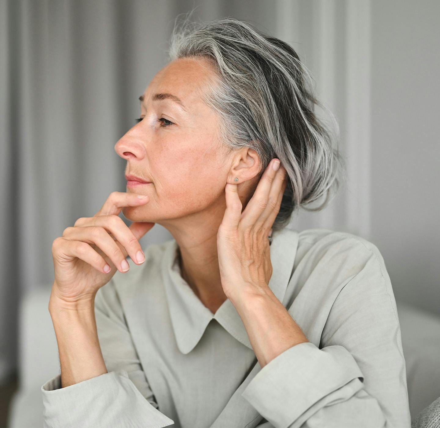 Women looking to side hands on chin