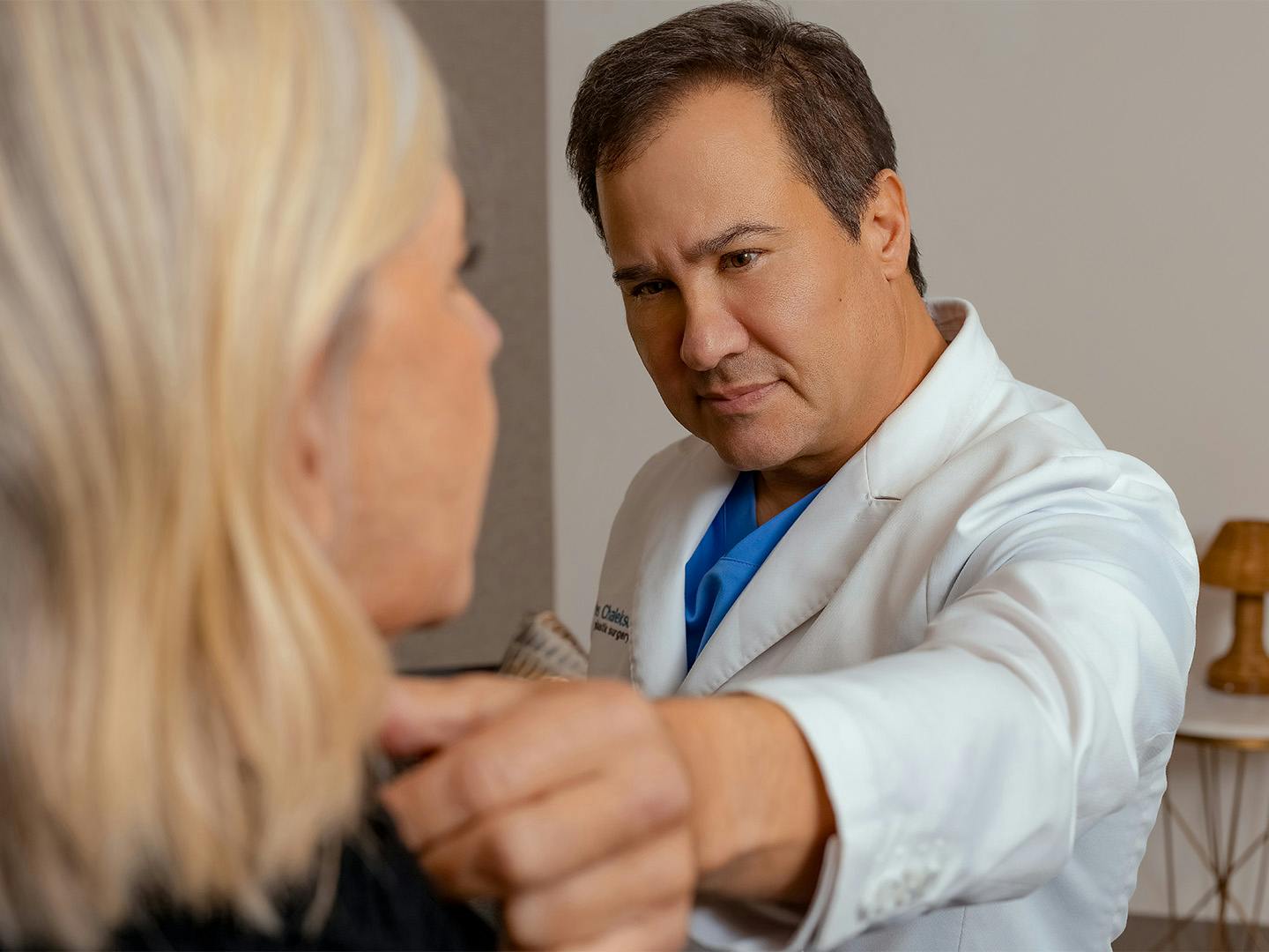Doctor touching women neck