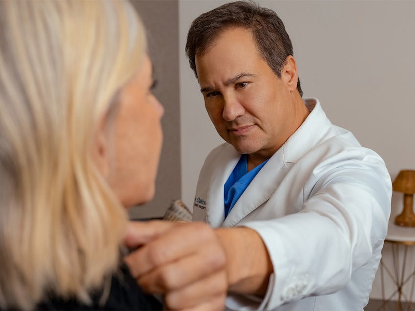 Doctor touching women neck