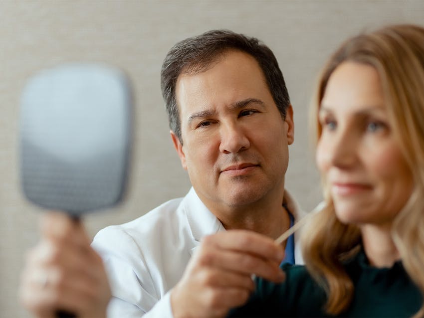 Doctor holding mirror