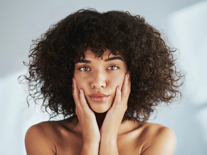 woman touching her face