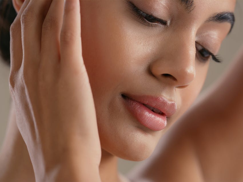 woman touching her face