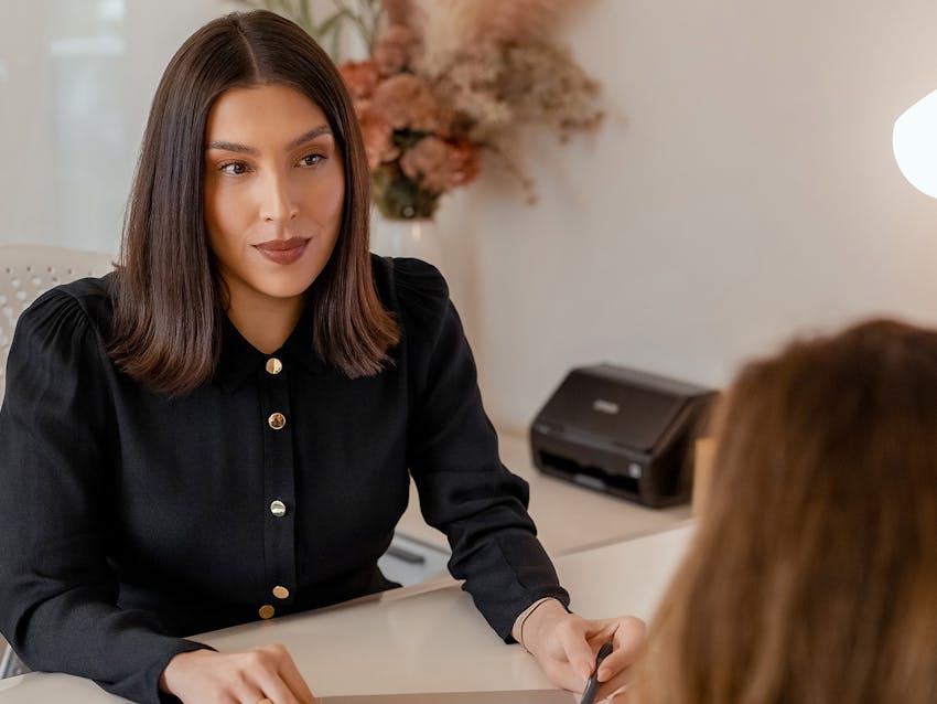 Women at desk with patient