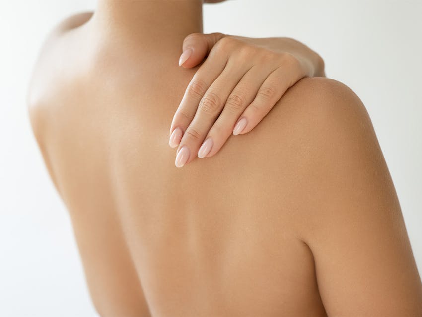 Women back side holding shoulde