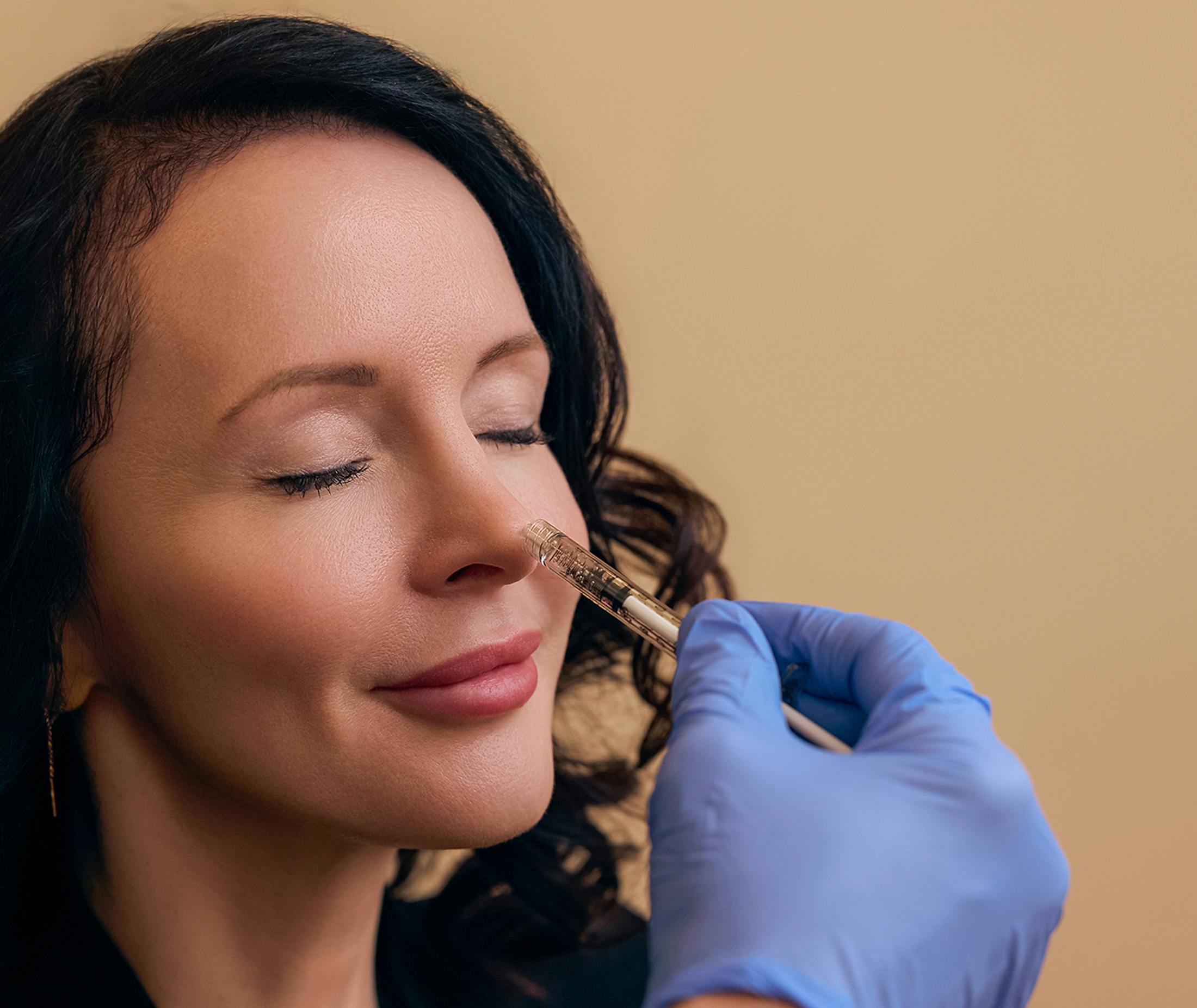 Doctor touching a woman's nose