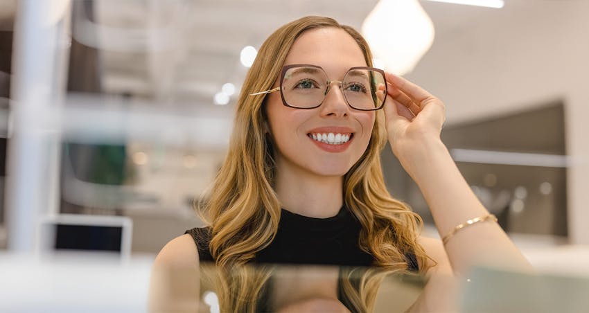 woman trying on glasses