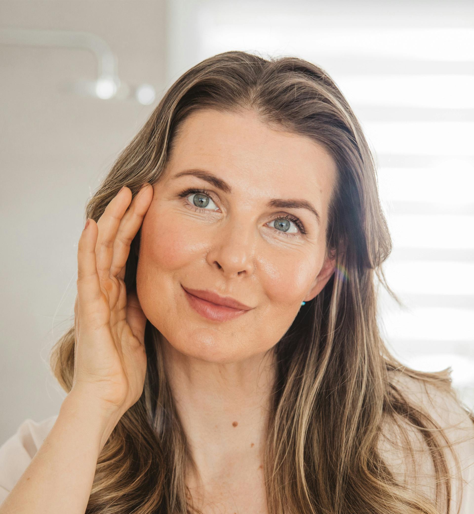 woman touching her face