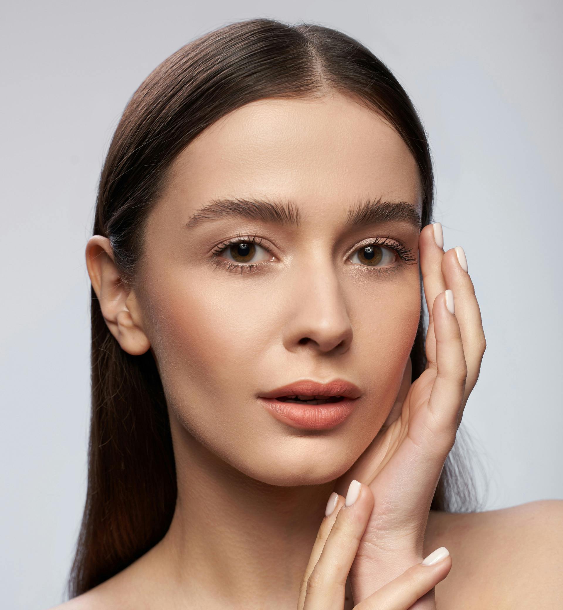woman touching her face