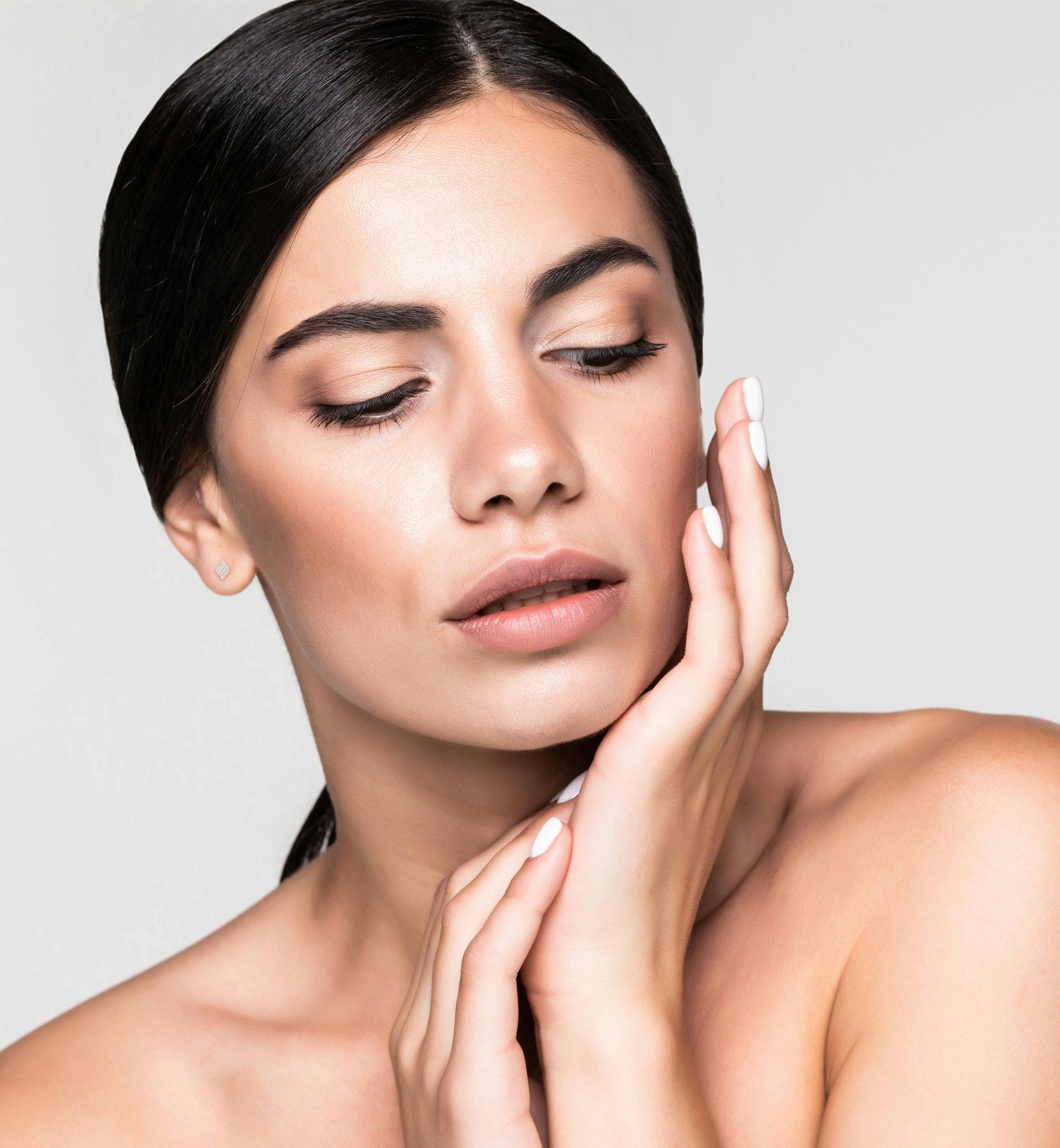 woman touching her face