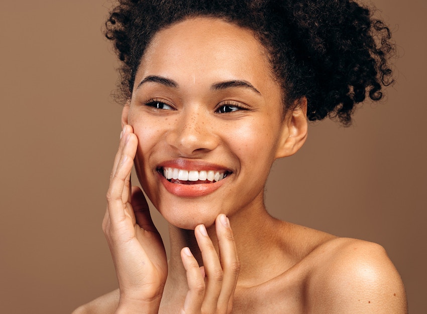 woman touching her face