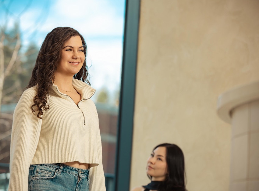 women standing and smiling