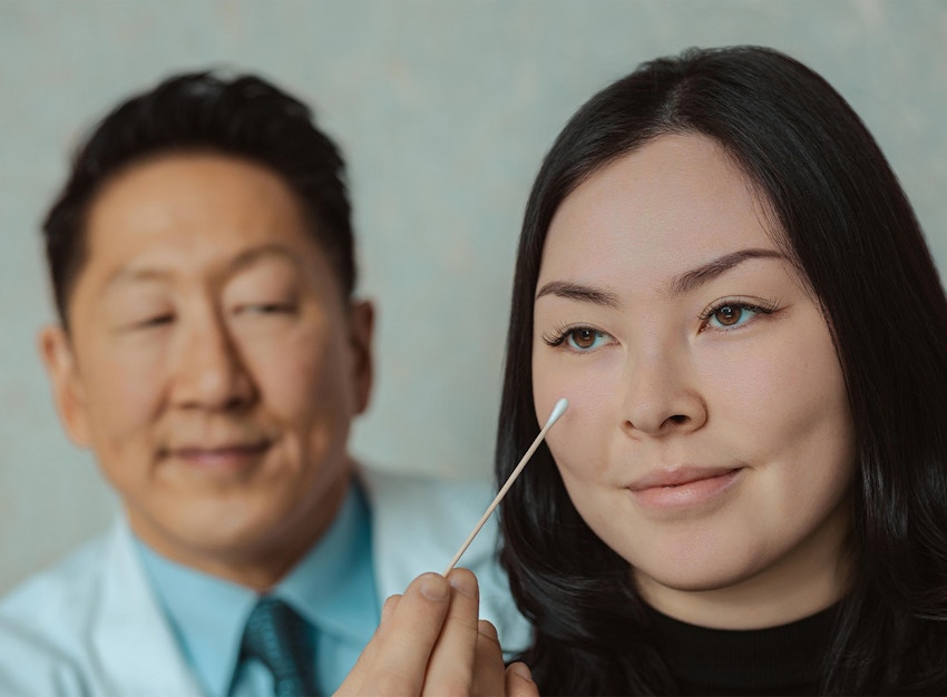 doctor pointing at a patient's eye