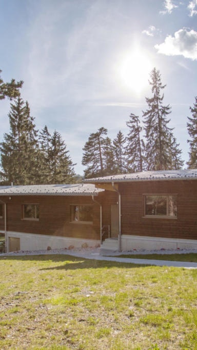 Ferienhaus Don Bosco Holzgebäude mit grosser Fassade und grüner Wiese