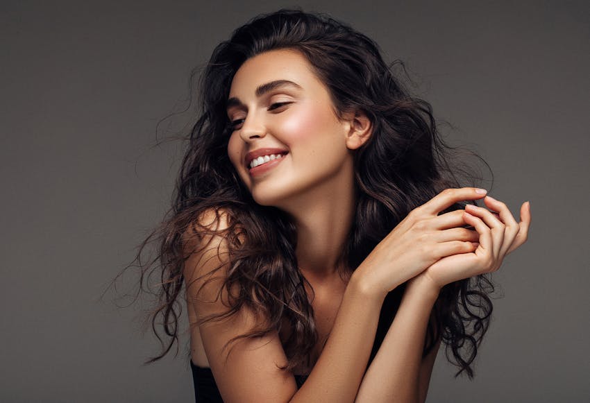 lady smiling while displaying chin implant results in Dallas Tx