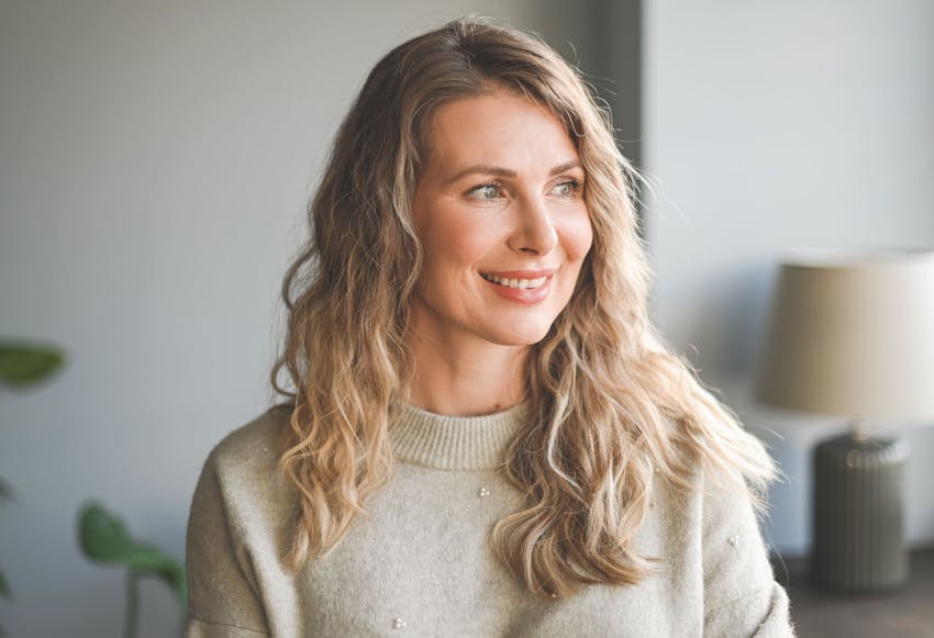 Woman with blonde hair looking to the side