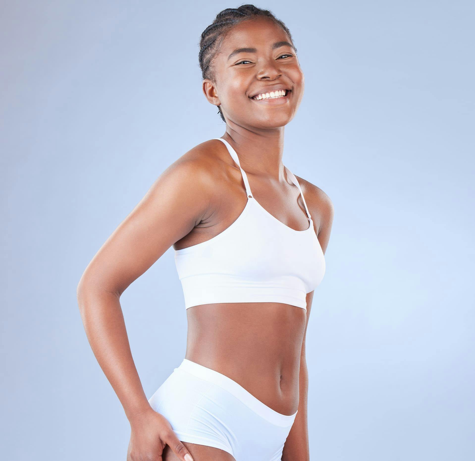 smiling woman in white bikini posing for a picture