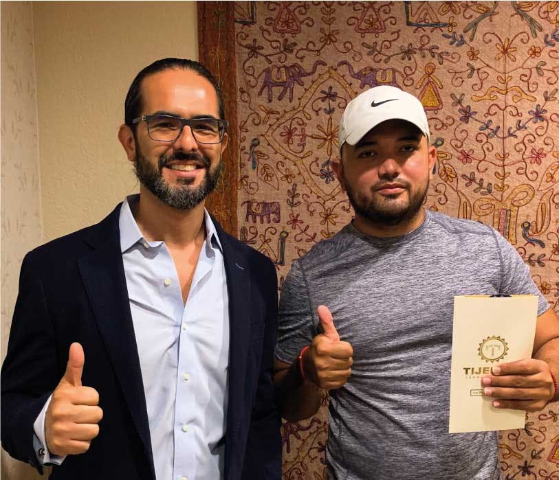two people posing with their thumbs up