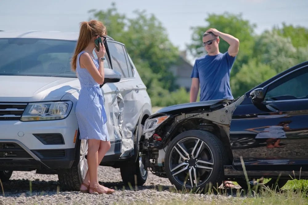 T-Bone Car Accident Two drivers inspecting their cars after a t-bone car accident