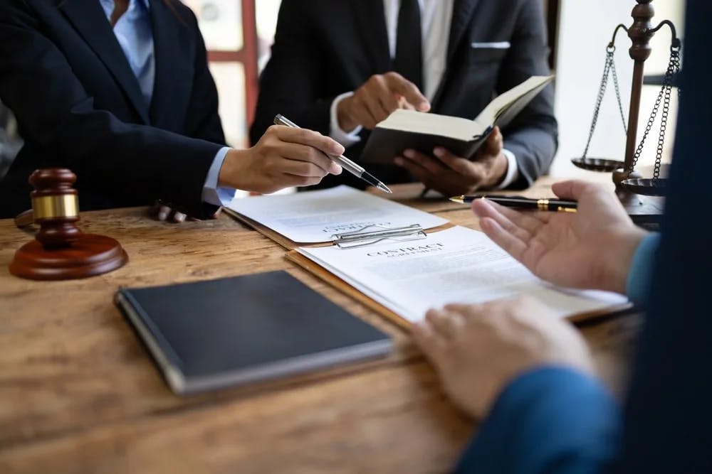 Documents Lawyer with various documents at desk
