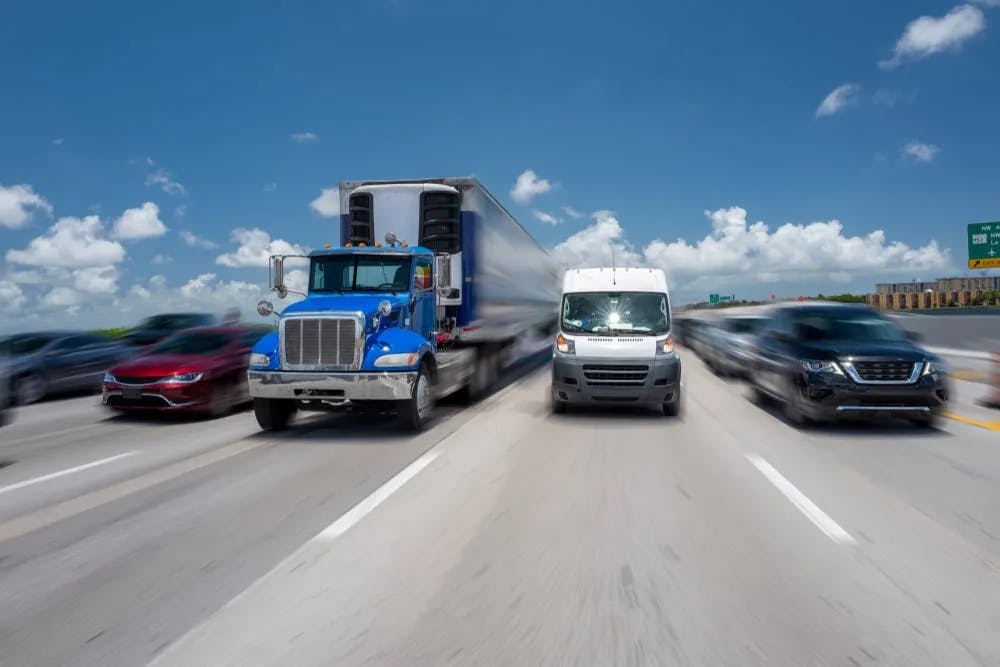 Multiple vehicles speeding on a highway