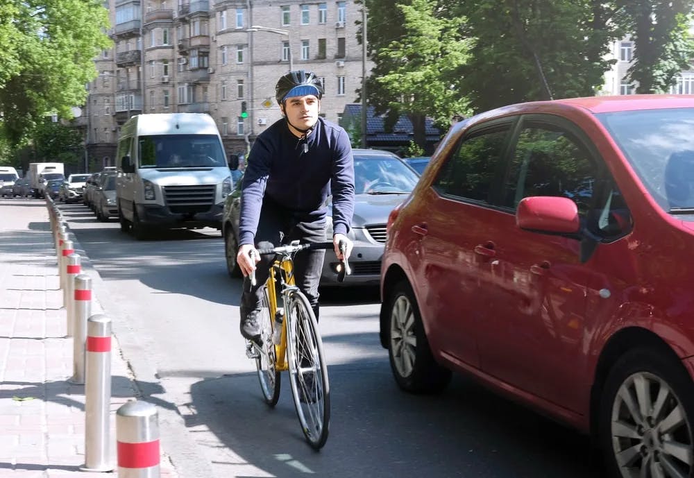 Closeup of man cycling through city roads