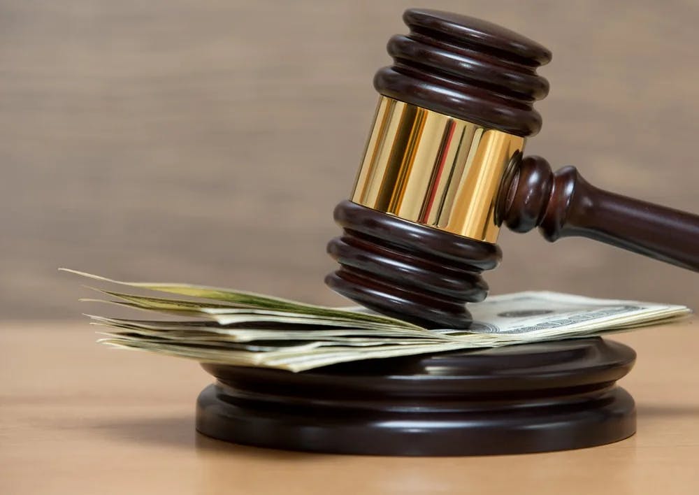 Gavel with dollar bills