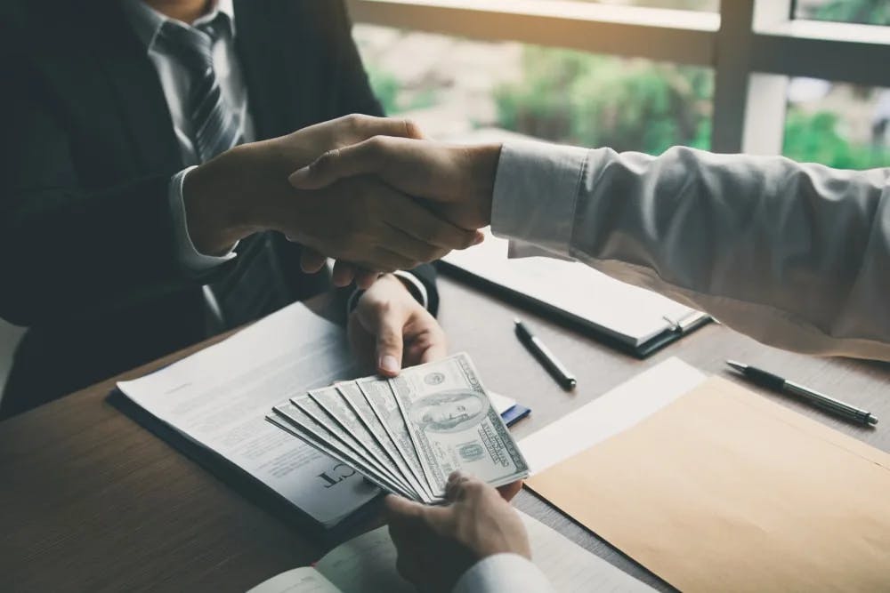 Client paying their lawyer with bills