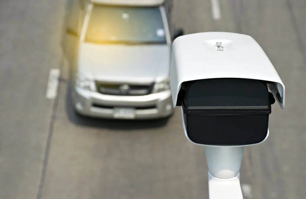 Speeding vehicle being captured by a speed camera