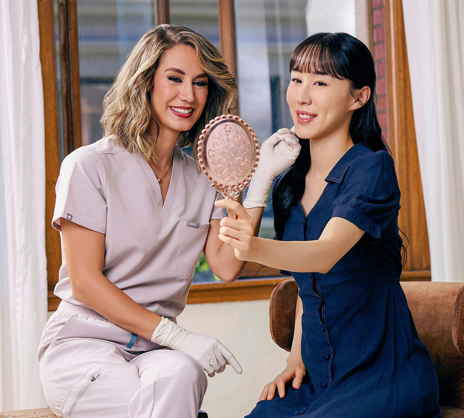 women smiling at a mirror